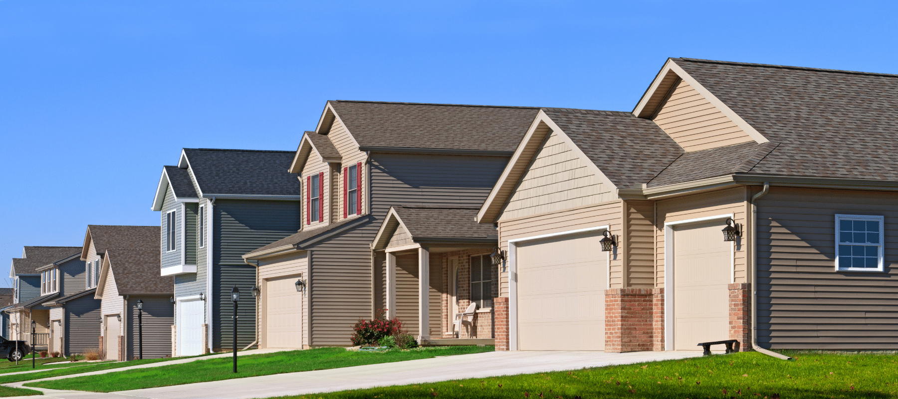 Row of modern suburban homes with driveways and garages