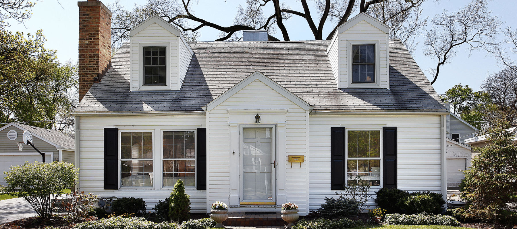 closeup of a white home with black shutters in helotes texas